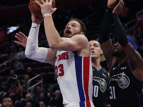 Detroit Pistons forward Blake Griffin (23) shoots as Orlando Magic forward Aaron Gordon (00) and guard Terrence Ross (31) defend during the first half of an NBA basketball game, Wednesday, Jan. 16, 2019, in Detroit.