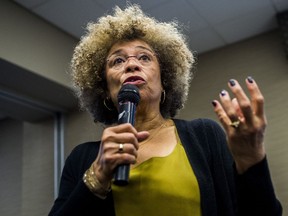 FILE - In this Feb. 19, 2015 file photo, Angela Davis speaks during her visit to the University of Michigan-Flint, in Flint, Mich.  An Alabama civil rights museum has reversed course after a public outcry and has decided to give political activist Angela Davis an award that it offered then rescinded. The Birmingham Civil Rights Institute said in a statement Friday, Jan. 25, 2019,  that its board has voted to reaffirm Davis as the recipient of the human rights award.