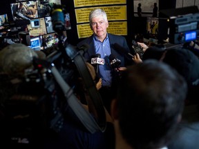 FILE - In this Monday, June 6, 2016 file photo, journalists surround around Gov. Rick Snyder to ask him questions about the Flint water crisis after he toured skilled trades programs at Mott Community College in Flint, Mich. Flint had one of the worst man-made environmental debacles in U.S. history. Lead infected the distribution system in the city of 100,000, which was under the thumb of financial managers appointed by Snyder. Officials finally took action after a doctor reported high levels of lead in children.