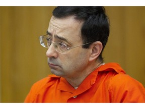 FILE - In this Jan. 31, 2018, file photo, Larry Nassar appears for his sentencing at Eaton County Circuit Court in Charlotte, Mich. A U.S. Education report is blasting Michigan State University's handling of sexual assaults related to the investigation of now-imprisoned sports doctor Nassar and other campus crime. The Lansing State Journal reports Wednesday, Jan. 30, 2019, that Education officials have been looking into the East Lansing school's compliance with the Clery Act which requires notifying the campus community about crimes in a timely manner.