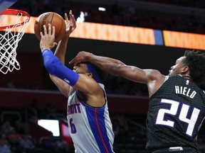 CORRECTS PISTONS PLAYER TO BRUCE BROWN, INSTEAD OF KALIN LUCAS - Sacramento Kings guard Buddy Hield (24) fouls Detroit Pistons' Bruce Brown during the first half of an NBA basketball game in Detroit, Saturday, Jan. 19, 2019.