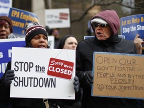 People rally to call for an end to the partial government shutdown in Detroit, Thursday, Jan. 10, 2019.