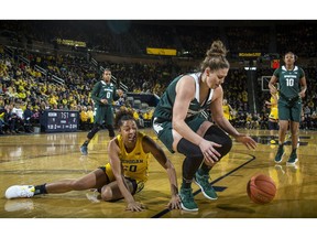 Michigan guard Deja Church, bottom left, loses the ball to Michigan State center Jenna Allen, center, in the first half of an NCAA college basketball game at Crisler Center in Ann Arbor, Mich., Sunday, Jan. 27, 2019.