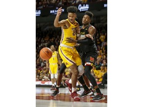 Maryland's Bruno Fernando knocks the ball away from Minnesota's Eric Curry (24) during an NCAA college basketball game Tuesday, Jan. 8, 2019, in Minneapolis.