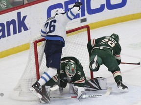 Winnipeg Jets' Blake Wheeler crashes into Minnesota Wild's goalie Devan Dubnyk after trying to score a goal in the first period of an NHL hockey game Thursday, Jan. 10, 2019, in St. Paul, Minn.