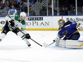 Dallas Stars' Devin Shore, left, is unable to score past St. Louis Blues goaltender Jake Allen during the first period of an NHL hockey game Tuesday, Jan. 8, 2019, in St. Louis.