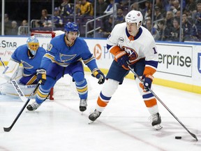 New York Islanders' Matt Martin, right, looks to pass as St. Louis Blues' Brayden Schenn and goaltender Jake Allen, left, defend during the first period of an NHL hockey game Saturday, Jan. 5, 2019, in St. Louis.