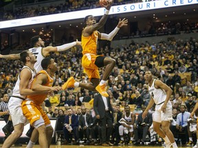 Tennessee's Jordan Bone, center, shoots between Missouri defenders during the first half of an NCAA college basketball game Tuesday, Jan. 8, 2019, in Columbia, Mo.