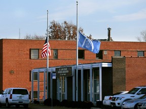 Flags fly at half-staff in front of the St. Louis Police Officers Association on Thursday, Jan. 24, 2019, following the shooting death of a police officer.  Authorities say a St. Louis police officer has accidentally shot and killed another officer. The shooting happened around 1 a.m. Thursday when two on-duty male officers went to one of their homes during their shift. Police Chief John Hayden said during a news conference that a 24-year-old off-duty officer was shot in the chest when she stopped by the home.