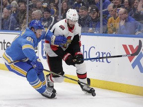St. Louis Blues' Vladimir Tarasenko (91) beats Ottawa Senators' Ben Harpur (67) to a loose puck in the first period of an NHL hockey game, Saturday, Jan. 19, 2019, in St. Louis.
