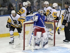 New York Rangers goaltender Henrik Lundqvist (30) reacts as the Pittsburgh Penguins celebrate a goal by Pittsburgh Penguins left wing Tanner Pearson (14) during the third period of an NHL hockey game Wednesday, Jan. 2, 2019, at Madison Square Garden in New York. The Penguins defeated the Rangers 7-2.