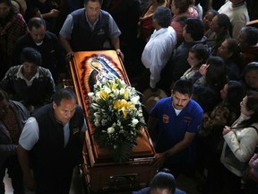 People carry the coffin of a victim of the gas pipeline that exploded in the village of Tlahuelilpan, Mexico, Sunday, Jan. 20, 2019. A massive fireball that engulfed locals scooping up fuel spilling from a pipeline ruptured by thieves in central Mexico killed dozens of people and badly burned dozens more on Jan. 18. An image of Our Lady of Guadalupe decorates the coffin.