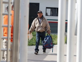 Carlos Catarldo Gomez, of Honduras, center, is escorted by Mexican officials after leaving the United States, the first person returned to Mexico to wait for his asylum trial date, in Tijuana, Mexico, Tuesday, Jan. 29, 2019. The Trump administration has launched an effort to make asylum seekers wait in Mexico while their cases wind through U.S. immigration courts despite mixed signals from Mexico on key issues.