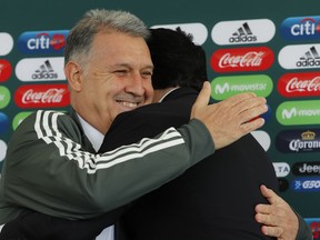 Gerardo Martino is presented as the new coach of Mexico's national soccer team, during a news conference in Mexico City, Monday, Jan. 7, 2019. At right is Yon De Luisa, president of the Mexican Football Federation.