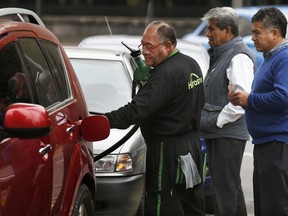 Commuters line up to fill their fuel tanks at a gas station, some of which are limiting how much each client can purchase, in Mexico City, Monday, Jan. 14, 2019. Mexico President Andres Manuel Lopez Obrador has vowed to get the upper hand on fuel thieves and is trying to choke off their supply by taking several major pipelines off line. However, tanker trucks used to deliver the fuel couldn't distribute fuel at the same levels as the pipelines, triggering shortages and panic buying.