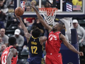 Toronto Raptors center Serge Ibaka (9) goes up to block the shot of Indiana Pacers guard Tyreke Evans (12) during the first half of an NBA basketball game in Indianapolis, Wednesday, Jan. 23, 2019.