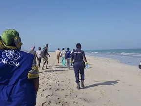 Rescuers search for survivors on the beach after two boats carrying migrants capsized off the shore near Godoria, in northeast Djibouti Tuesday, Jan. 29, 2019. More than 130 migrants were thought to be missing after the two boats capsized Tuesday off the East African nation of Djibouti, the International Organization for Migration said. (International Organization for Migration via AP)
