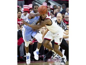 North Carolina's Kenny Williams, left, and North Carolina State's C.J. Bryce, right, battle for a loose ball during the first half of an NCAA college basketball game in Raleigh, N.C., Tuesday, Jan. 8, 2019.