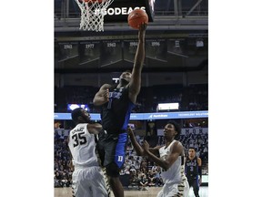 Duke's Zion Williamson (1) drives between Wake Forest's Ikenna Smart (35) and Jaylen Hoard during the first half of an NCAA college basketball game in Winston-Salem, N.C., Tuesday, Jan. 8, 2019.