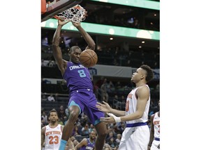 Charlotte Hornets' Bismack Biyombo (8) dunks against New York Knicks' Kevin Knox (20) during the first half of an NBA basketball game in Charlotte, N.C., Monday, Jan. 28, 2019.