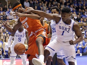 Duke's Zion Williamson (1) and Syracuse's Paschal Chukwu (13) chase a rebound during the first half of an NCAA college basketball game in Durham, N.C., Monday, Jan. 14, 2019.