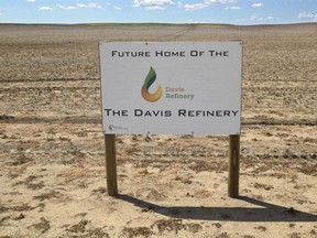 FILE - This July 19, 2018, file photo shows a sign on property, near southwest Belfield, N.D., for the future home of the Davis Refinery near Theodore Roosevelt National Park. An administrative law judge in North Dakota is recommending that state officials issue a water permit for an oil refinery being developed near Theodore Roosevelt National Park. Area landowners challenged a proposed permit that would allow the Davis Refinery to draw water from an underwater aquifer.