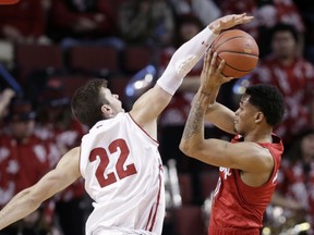 Nebraska's James Palmer Jr., right, tries to shoot as Wisconsin's Ethan Happ (22) defends during the first half of an NCAA college basketball game in Lincoln, Neb., Tuesday, Jan. 29, 2019.