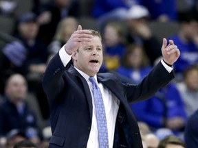 Marquette coach Steve Wojciechowski gestures to his players during the first half of an NCAA college basketball game against Creighton in Omaha, Neb., Wednesday, Jan. 9, 2019.