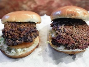 A conventional beef burger, left, is seen Friday, Jan. 11, 2019, next to "The Impossible Burger", right, a plant-based burger containing wheat protein, coconut oil and potato protein among it's ingredients. The ingredients of the Impossible Burger are clearly printed on the menu at Stella's Bar & Grill in Bellevue, Neb., where the meat and non-meat burgers are served. More than four months after Missouri became the first U.S. state to regulate the term "meat" on product labels, Nebraska's powerful farm groups are pushing for similar protection from veggie burgers, tofu dogs and other items that look and taste like meat.
