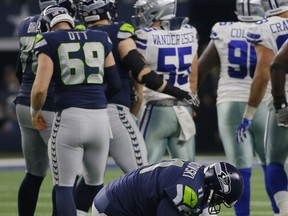 Seattle Seahawks place kicker Sebastian Janikowski (11) falls to the ground after suffering an unknown injury to his left leg attempting a long field goal attempt against the Dallas Cowboys in the first half of the NFC wild-card NFL football game in Arlington, Texas, Saturday, Jan. 5, 2019.