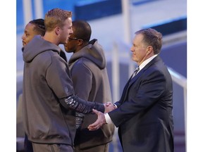New England Patriots head coach Bill Belichick talks to Los Angeles Rams' Jared Goff during Opening Night for the NFL Super Bowl 53 football game Monday, Jan. 28, 2019, in Atlanta.