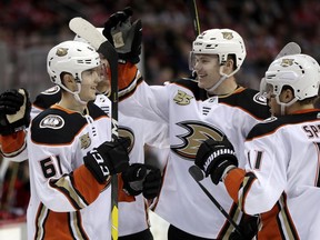 Anaheim Ducks players celebrate a goal by right wing Troy Terry, left, during the first period of an NHL hockey game against the New Jersey Devils, Saturday, Jan. 19, 2019, in Newark, N.J.