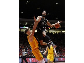 Nevada forward Caleb Martin (10) is fouled by New Mexico's Vladimir Pinchuk, left, of Germany, during the first half of an NCAA college basketball game in Albuquerque, N.M., Saturday, Jan. 5, 2019.