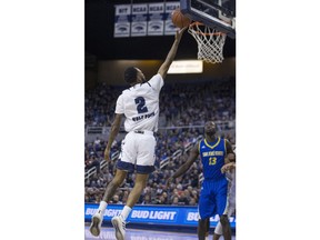 Nevada guard Corey Henson (2) shoots a layup as San Jose State' Christian Anigwe watches during the first half of an NCAA college basketball game in Reno, Nev., Wednesday, Jan. 9, 2019.