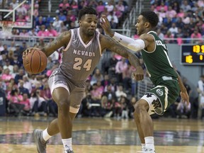 Nevada forward Jordan Caroline (24) drives past Colorado State guard Hyron Edwards (0) during the first half of an NCAA college basketball game in Reno, Nev., Wednesday, Jan. 23, 2019.