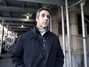 FILE - In this Dec. 7, 2018 file photo, Michael Cohen, former lawyer to President Donald Trump, leaves his apartment building in New York.  Cohen is acknowledging that he paid a technology company to falsely improve Trump's standing in two online polls.