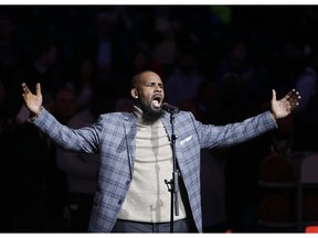 FILE - In this Nov. 17, 2015, file photo, musical artist R. Kelly performs the national anthem before an NBA basketball game between the Brooklyn Nets and the Atlanta Hawks in New York.  For Grammy-nominated singer Joe, singing the hit song R. Kelly wrote and produced for him is out of the question. "I've stopped performing the song," he said in a statement to The Associated Press, referring to "More & More," a Top 20 R&B success released in 2003. "No music or intellectual property is worth being inconsiderate to the feelings or pain of others," 45-year-old Joe continued.
