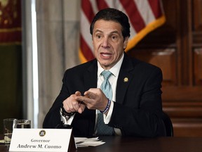 FILE - In this Tuesday,  Jan. 29, 2019 file photo, New York Gov. Andrew Cuomo meets with gun safety advocates in the Red Room during a news conference at the state Capitol in Albany, N.Y.  Cuomo is shrugging off criticism from Roman Catholic leaders over his support of a new state abortion law. Speaking on public radio Tuesday, Cuomo said he is duty bound to separate his religious views from his work as governor.