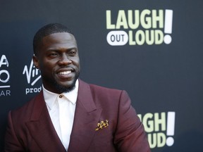 FILE - In this Aug. 3, 2017 file photo, Kevin Hart poses at Kevin Hart's "Laugh Out Loud" new streaming video network launch event at the Goldstein Residence in Beverly Hills, Calif.  Prodded by Ellen DeGeneres,  Hart says he'll reconsider his decision to step down as host of the Academy Awards. Two days after he was named as host last Dec. 2018, Hart backed off when some of his homophobic tweets from a decade ago resurfaced.