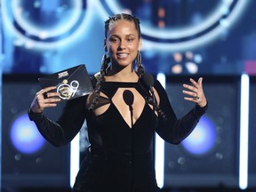 FILE - In this Jan. 28, 2018 file photo, Alicia Keys presents the award for record of the year at the 60th annual Grammy Awards at Madison Square Garden in New York.  The Recording Academy announced Tuesday, Jan. 15, 2019,  that Keys will host the Feb. 10 Grammys for the first time.  The show will air live on CBS in Los Angles.