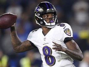 FILE - In this Saturday, Dec. 22, 2018 file photo, Baltimore Ravens quarterback Lamar Jackson passes against the Los Angeles Chargers during the first half in an NFL football game in Carson, Calif.  The Ravens are making their first postseason appearance since 2014.