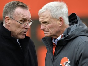 FILE - In this Dec. 10, 2017, file photo, Cleveland Browns general manager John Dorsey, left, talks with owner Jimmy Haslam before an NFL football game between the Green Bay Packers and the Cleveland Browns, in Cleveland. One week into their coaching search, the Browns are taking a timeout. After conducting interviews with seven candidates in seven days, general manager John Dorsey and members of the team's search committee, which includes owner Jimmy Haslam, were not expected to meet with anyone on Tuesday, Jan. 8, 2019, and could be evaluating their next move.