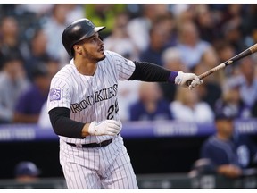 FILE - In this Aug. 21, 2018, file photo, Colorado Rockies' Nolan Arenado watches his RBI-double off San Diego Padres pitcher Robbie Erlin during a baseball game in Denver. Arenado and the Rockies have agreed to a $26 million, one-year deal to avoid arbitration, the largest ever one-year salary for an arbitration-eligible player. Colorado announced the deal Thursday, Jan. 31.