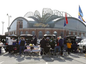 FILE - In this April 2, 2018, file photo, fans tailgate in the parking lot of Miller Park before a home opener baseball game between the Milwaukee Brewers and St. Louis Cardinals, in Milwaukee. The Brewers' home ballpark will be renamed when MillerCoors' naming rights expire following the 2020 season. MillerCoors said in a statement Tuesday, Jan. 22, 2019, the rights to Miller Park will go to American Family Insurance beginning in 2021.