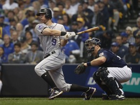 FILE - In this Oct. 5, 2018, file photo, Colorado Rockies' DJ LeMahieu hits a single during the third inning of Game 2 of the National League Divisional Series baseball game against the Milwaukee Brewers, in Milwaukee. A star second baseman for Colorado, LeMahieu is set to join a crowded New York Yankees infield. LeMahieu became a free agent after the season and got a $24 million, two-year contract with the Yankees.