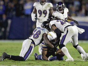 FILE - In this Dec. 22, 2018, file photo, Baltimore Ravens inside linebacker Patrick Onwuasor, left, and cornerback Brandon Carr force a fumble by Los Angeles Chargers tight end Antonio Gates during the second half in an NFL football game, in Carson, Calif. Some juicy rematches highlight wild-card weekend, in which, well, just about any of the eight teams advancing wouldn't be a surprise. Seattle beat Dallas early this season, and Baltimore handled the Los Angeles Chargers late. The Colts and Texans split two games. Only the Eagles and Bears didn't face off.