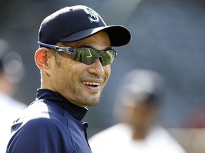 FILE - In this Tuesday, July 10, 2018 file photo, Seattle Mariners' Ichiro Suzuki, of Japan, smiles during warm ups before a baseball game against the Los Angeles Angels in Anaheim, Calif. Ichiro Suzuki has agreed to a minor-league deal with the Seattle Mariners paving the way for the 45-year-old to play in Seattle's season-opening series in Japan. Suzuki's agent, John Boggs, confirmed the agreement on Wednesday, Jan. 23, 2019.