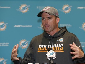 FILE - In this June 5, 2017, file photo, Miami Dolphins associate head coach/special teams coordinator Darren Rizzi gestures as he speaks after an NFL football practice, in Davie, Fla. Rizzi is the fifth candidate to interview for their head coaching job. Rizzi joined the Miami staff in 2009 and has won the endorsement of such current and former Dolphins as Jason Taylor, Brian Hartline, Kiko Alonso and Kenyan Drake. He has been special teams coordinator since 2011 and has also been associate head coach since 2017.