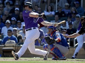 FILE - In this March 5, 2018, file photo, Colorado Rockies' DJ LeMahieu bats during a spring baseball game against the Chicago Cubs, in Scottsdale, Ariz. A person familiar with the negotiations tells The Associated Press that Gold Glove-winning free agent second baseman D.J. LeMahieu and the Yankees are nearing agreement on a two-year contract, a deal that would appear to eliminate New York as a destination for Manny Machado. The person spoke on condition of anonymity Friday, Jan. 11, 2019, because no agreement had been announced.