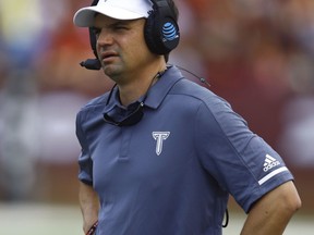 FILE - In this Sept. 1, 2018, file photo, Troy head coach Neal Brown watches during the first half of an NCAA college football game against Boise State, in Troy, Ala. West Virginia and Troy's Neal Brown are completing a deal to make him the next coach of the Mountaineers, two people familiar with the situation told The Associated Press on Friday, Jan. 4, 2018. The people spoke to AP on condition of anonymity because the contract was not yet final.
